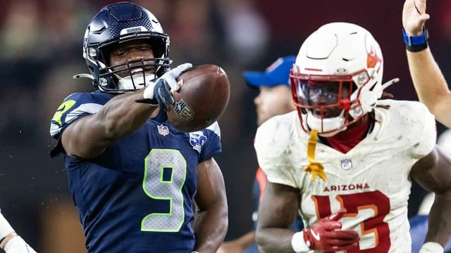 Sep 25, 2025; Glendale, Arizona, USA; Seattle Seahawks running back Kenneth Walker III (9) taunts an Arizona Cardinals defender at State Farm Stadium. Mandatory Credit: Mark J. Rebilas-Imagn Images