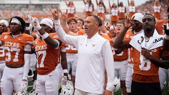 Sep 6, 2025; Austin, Texas, USA; Texas Longhorns head coach Steve Sarkisian and players hold up their horns with the fans during the singing of the Eyes of Texas after a victory over the San Jose State Spartans at Darrell K Royal-Texas Memorial Stadium. Mandatory Credit: Scott Wachter-Imagn Images