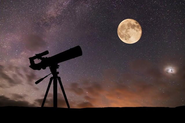 Telescope on the background of the starry sky and moon.