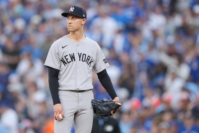 New York Yankees pitcher Luke Weaver (30) looks on after giving up an RBI single during the seventh inning against the Toronto Blue Jays  in Game 1 of baseball's American League Division Series, Saturday, Oct. 4, 2025, in Toronto. (Nathan Denette/The Canadian Press via AP)
