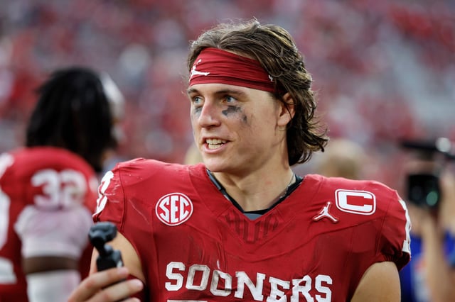 NORMAN, OKLAHOMA - SEPTEMBER 20:  Quarterback John Mateer #10 of the Oklahoma Sooners records a greeting for the fans after a 24-17 win over the Auburn Tigers at Gaylord Family Oklahoma Memorial Stadium on September 20, 2025 in Norman, Oklahoma.  (Photo by Brian Bahr/Getty Images)