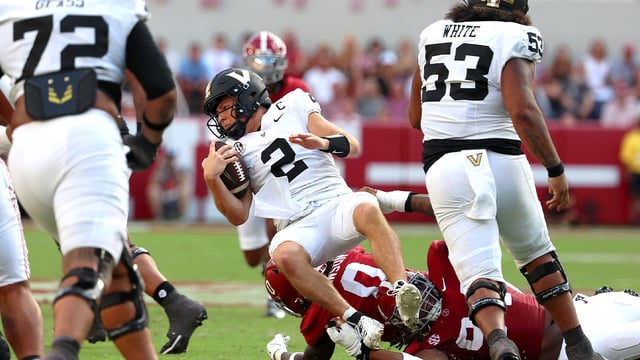 Oct 4, 2025; Tuscaloosa, Alabama, USA; Vanderbilt Commodores quarterback Diego Pavia (2) is tackled during the second half against the Alabama Crimson Tide at Saban Field at Bryant-Denny Stadium. Mandatory Credit: David Leong-Imagn Images