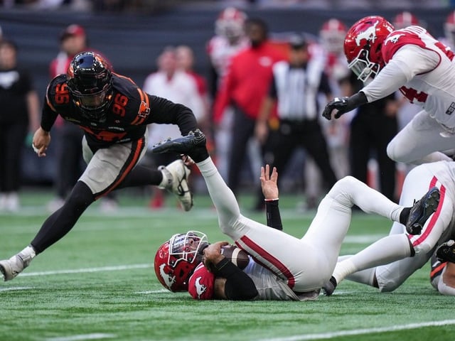 Calgary Stampeders quarterback Vernon Adams Jr. falls after being sacked by BC Lions’ Deontai Williams, not seen, as Bradlee Anae, back left, watches at BC Place in Vancouver on Saturday, Oct. 4, 2025.