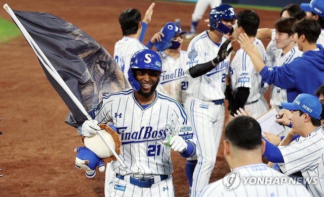 Lewin Diaz of the Samsung Lions is congratulated by teammates after hitting a three-run home run against the Kia Tigers during the clubs' Korea Baseball Organization (KBO) regular-season game at Daegu Samsung Lions Park in Daegu, 235 kilometers southeast of Seoul, on Sept. 30, 2025. It was Diaz's 50th home run of the season, making him the first foreign-born player in KBO history, and the fourth player overall, to reach the half-century mark. (Yonhap)