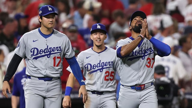 Los Angeles Dodgers two-way player Shohei Ohtani (17) and second baseman Tommy Edman (25) and right fielder Teoscar Hernandez (37) celebrate after defeating the Philadelphia Phillies in game one of the NLDS round for the 2025 MLB playoffs at Citizens Bank Park.Mandatory Credit: Bill Streicher-Imagn Images