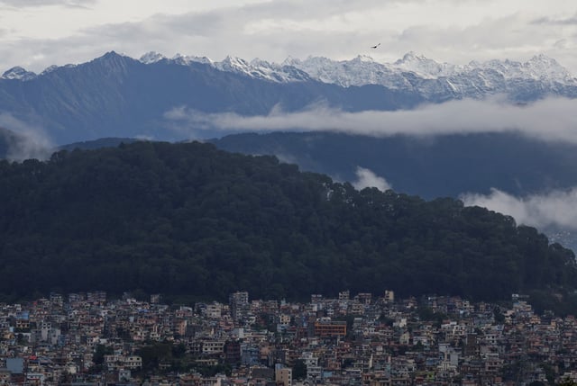 A snowcapped mountain range emerges over the valley as monsoon clouds clear following heavy rainfall in Kathmandu, Nepal, October 5, 2025. REUTERS/Navesh Chitrakar