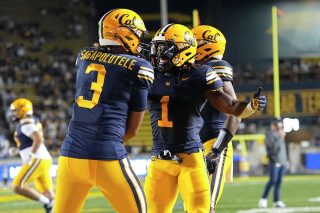 Cal running back Kendrick Raphael and quarterback Jaron-Keawe Sagapolutele celebrate after Raphael scored a first-quarter touchdown against Duke at Memorial Stadium on Saturday. 
