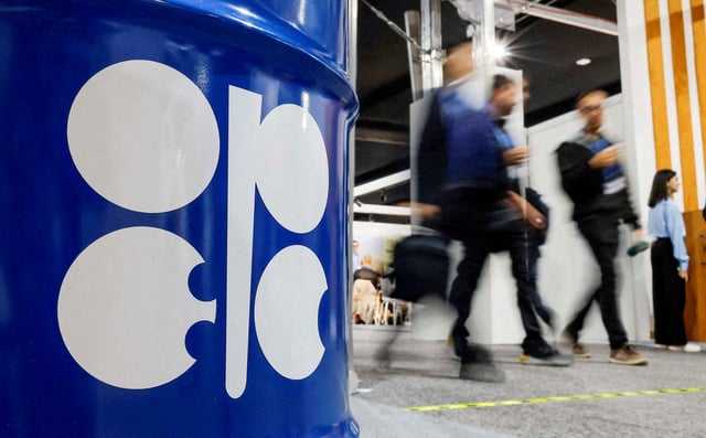 People walk past an installation depicting barrel of oil with the logo of Organization of the Petroleum Exporting Countries (OPEC) during the COP29 United Nations climate change conference in Baku, Azerbaijan November 19, 2024. REUTERS/Maxim Shemetov