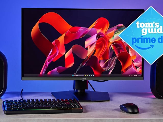MSI MPG 272URX monitor on desk with speakers and keyboard with Tom's Guide Prime Day badge