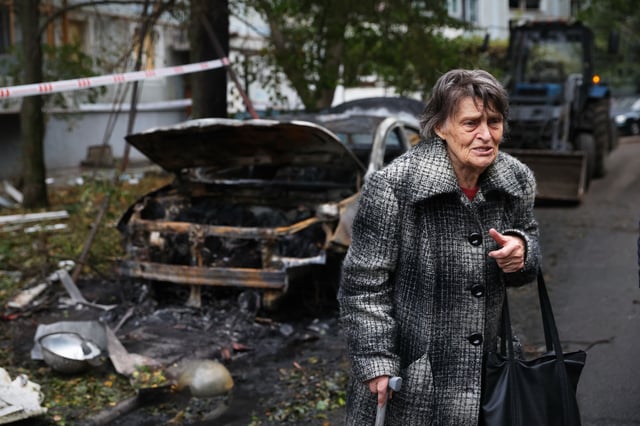 An elderly woman reacts next to the house destroyed by a Russian strike in Zaporizhzhia, Ukraine, Sunday, Oct. 5, 2025. (AP Photo/Kateryna Klochko)