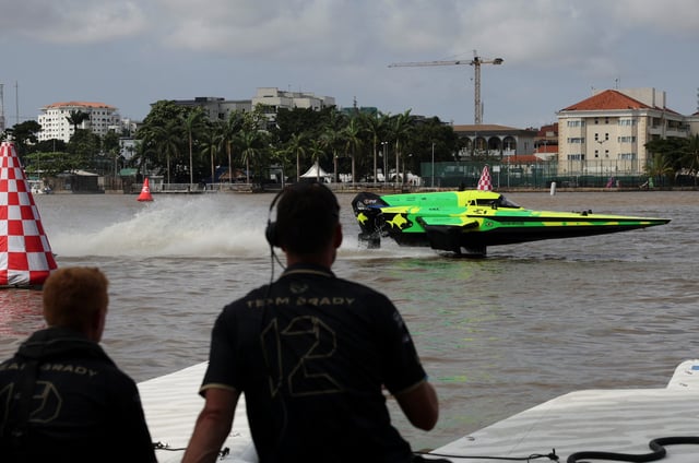 People look on as an E1 powerboat races across the Lagos lagoon during the qualifying time trial of the E1 Lagos GP powerboat championship debut in Lagos, Nigeria, October 4, 2025. REUTERS/Sodiq Adelakun