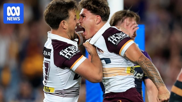 Two men celebrate after scoring a try
