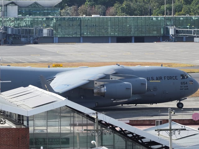 A U.S. military plane carrying Guatemalan migrants deported from the United States sits on the tarmac at La Aurora airport in Guatemala City, Monday, Jan. 27, 2025. (AP Photo/Moises Castillo)