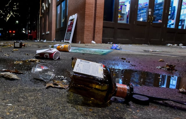 liqueur bottles litter the sidewalk at Bibb Street and Commerce Street following a shooting in downtown Montgomery, Ala., on early Sunday morning October 5, 2025.