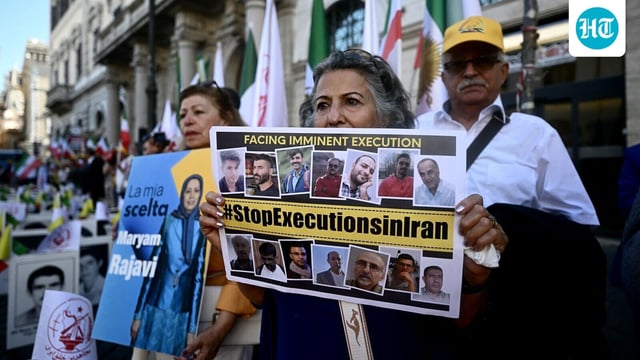 Protesters hold a placard against executions in Iran during a rally against the Iranian regime in Rome.