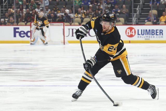Mar 13, 2025; Pittsburgh, Pennsylvania, USA;  Pittsburgh Penguins defenseman Matt Grzelcyk (24) shoots the puck against the St. Louis Blues during the first period at PPG Paints Arena. Mandatory Credit: Charles LeClaire-Imagn Images