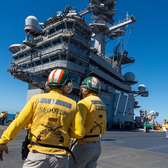 Crew members stand on the flight deck aboard the USS George H.W. Bush aircraft carrier in the Atlantic Ocean off the coast of Norfolk, Va., Saturday, Oct. 4, 2025. (AP Photo/Alex Brandon, File)