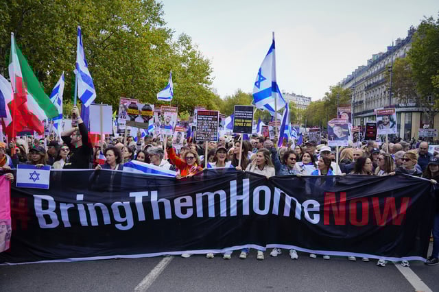 A banner with the text "bring them home" is seen before a march calling for the release of the Israeli hostages held by Hamas on the Place de la Republique on October 5, 2025 in Paris, France.