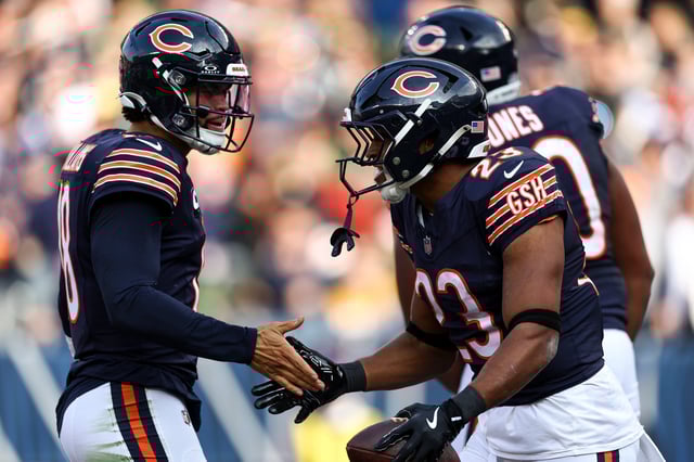 Roschon Johnson #23 of the Chicago Bears celebrates with Caleb Williams #18 after scoring a touchdown during an NFL football game against the Green Bay Packers at Soldier Field on November 17, 2024 in Chicago, Illinois. (Photo by Kevin Sabitus/Getty Images)