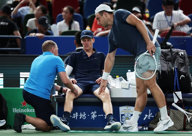 Tennis - ATP Masters 1000 - Shanghai Masters - Qizhong Forest Sports City Arena, Shanghai, China - October 5, 2025 Italy's Jannik Sinner receives medical attention before retiring due to an injury in his round of 32 match against Netherlands' Tallon Griekspoor REUTERS/Go Nakamura     TPX IMAGES OF THE DAY