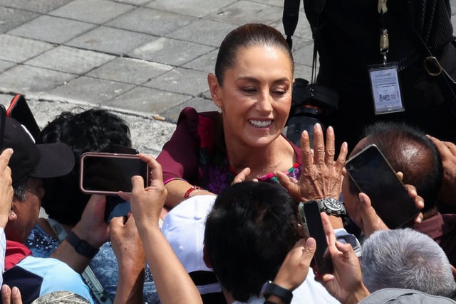 Mexico's President Claudia Sheinbaum greets supporters, as she arrives to deliver a speech marking her first year in office, reporting on government actions included in her first State of the Union address, to supporters and government officials at Zocalo Square, in Mexico City, Mexico, October 5, 2025. REUTERS/Henry Romero