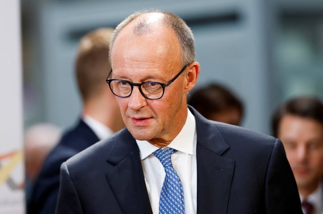 Germany's Chancellor Friedrich Merz attends the ceremony of signing the golden book of Saarbruecken, on the day of the celebrations to mark the 35th anniversary of Germany's Unification Day, in Saarbruecken, Germany, October 3, 2025. REUTERS/Heiko Becker
