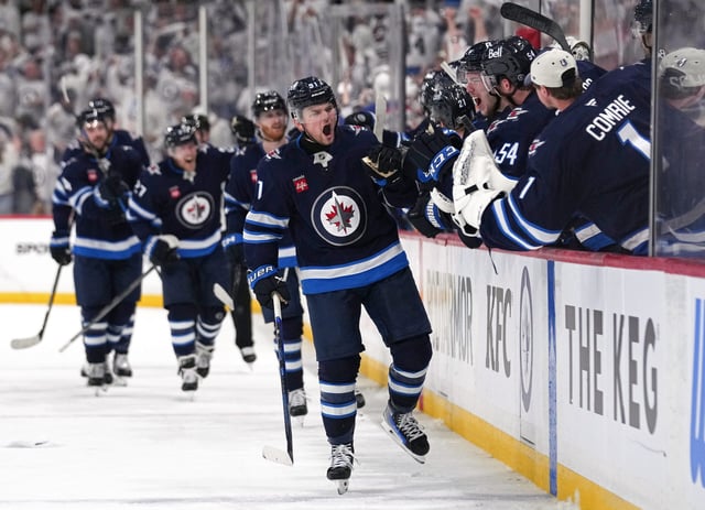 Cole Perfetti of the Winnipeg Jets is congratulated by his teammates after scoring the tying goal at 19:57 during the third period against the St. Louis Blues in Game Seven of the First Round of the 2025 Stanley Cup Playoffs (Photo by Cameron Bartlett/Getty Images)