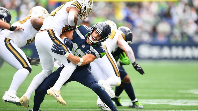 Sep 21, 2025; Seattle, Washington, USA; Seattle Seahawks wide receiver Cooper Kupp (10) blocks New Orleans Saints safety Justin Reid (21) during the first quarter at Lumen Field. Mandatory Credit: Steven Bisig-Imagn Images