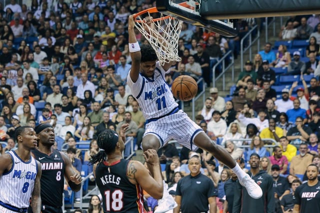 Orlando Magic guard Jase Richardson (11) dunks against the Miami Heat during the second half of a preseason NBA basketball game in San Juan, Puerto Rico, Saturday, Oct. 4, 2025. (AP Photo/Alejandro Granadillo)