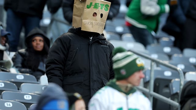 Dec 22, 2024; East Rutherford, New Jersey, USA; A New York Jets fan wears a paper bag on his head during the fourth quarter against the Los Angeles Rams at MetLife Stadium. Mandatory Credit: Brad Penner-Imagn Images