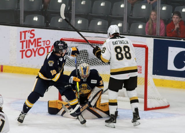 Frontenacs Jacob Battaglia (no. 88) looks for a rebound in the goalmouth but Erie Otters netminder Charlie Burns smothers the puck in first period action on Sunday, Oct. 5, 2025 at Slush Puppie Place in Kingston. Photo by Gare Joyce/Kingston Whig-Standard.