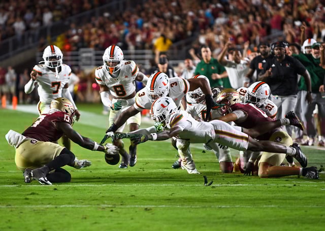 David Lebowitz, Staff Photographer - Multiple defenders dive toward a loose ball against FSU on October 4, 2025.