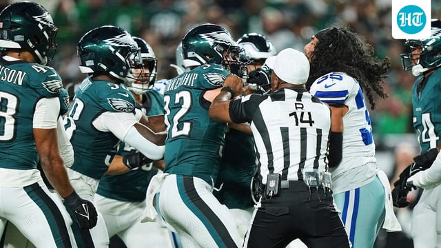 Philadelphia Eagles safety Reed Blankenship (32) and Dallas Cowboys' Marist Liufau, right, are separated by referee Shawn Smith (14)