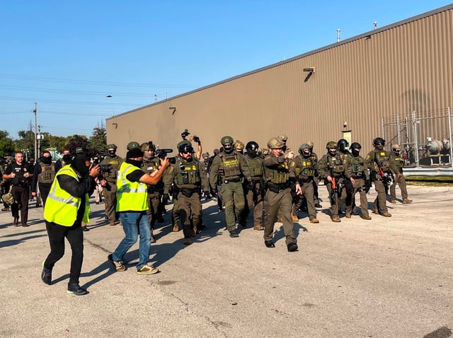 Federal police walk outside an ICE immigrant jail in Broadview, Illinois on October 3, 2025.