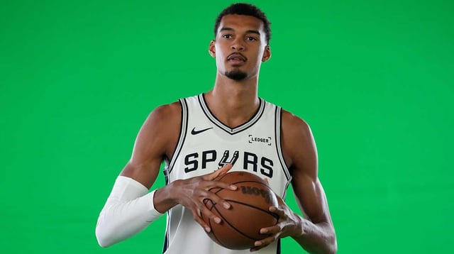 Sep 29, 2025; San Antonio, TX, USA; San Antonio Spurs forward-center Victor Wembanyama (1) poses for photos during Media Day at Victory Capital Performance Center in San Antonio. Mandatory Credit: Scott Wachter-Imagn Images