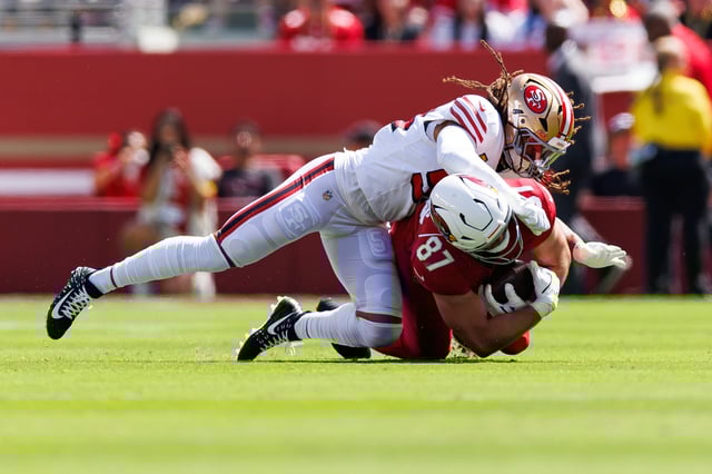 SANTA CLARA, CALIFORNIA - SEPTEMBER 21: Fred Warner #54 of the San Francisco 49ers tackles Tip Reiman #87 of the Arizona Cardinals during the first half of an NFL football game at Levi's Stadium on September 21, 2025 in Santa Clara, California. (Photo by Brooke Sutton/Getty Images)