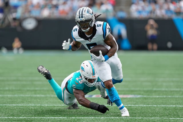 Carolina Panthers running back Rico Dowdle runs past Miami Dolphins linebacker Tyrel Dodson during the first half of Sunday's game in Charlotte, N.C. (AP Photo/Jacob Kupferman)