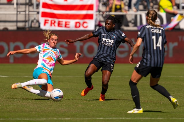 Oct 5, 2025; Washington, District of Columbia, USA; San Diego Wave FC defender Hanna Lundkvist (6) slide tackles the ball from Washington Spirit forward Rosemonde Kouassi (19) in the first half at Audi Field. Mandatory Credit: Emily Faith Morgan-Imagn Images