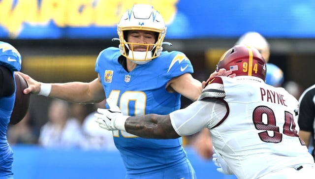 Chargers quarterback Justin Herbert (10) is pressured by Washington Commanders nose tackle Daron Payne (94) in the first half of the game at SoFi Stadium in Inglewood on Sunday, Oct. 5, 2025. (Photo by Terry Pierson, The Press-Enterprise/SCNG)