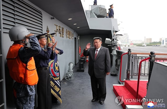 This photo, carried by North Korea's official Korean Central News Agency on Oct. 6, 2025, shows the North's leader Kim Jong-un (R) visiting the 5,000-ton destroyer, named the Choe Hyon, the previous day. (For Use Only in the Republic of Korea. No Redistribution) (Yonhap)