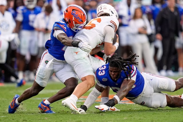 Florida linebacker Jaden Robinson, left, and defensive lineman Brien Taylor Jr. (33) sack Texas quarterback Arch Manning during the second half of an NCAA college football game, Saturday, Oct. 4, 2025, in Gainesville, Fla. (AP Photo/John Raoux)
