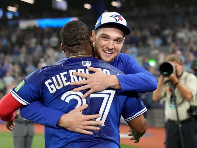 Toronto Blue Jays pitcher Trey Yesavage (39) and teammate Toronto Blue Jays first baseman Vladimir Guerrero Jr. (27) celebrate following their 13-7 win over the New York Yankees, after MLB American League Division Series baseball action in Toronto, Sunday, Oct. 5, 2025.