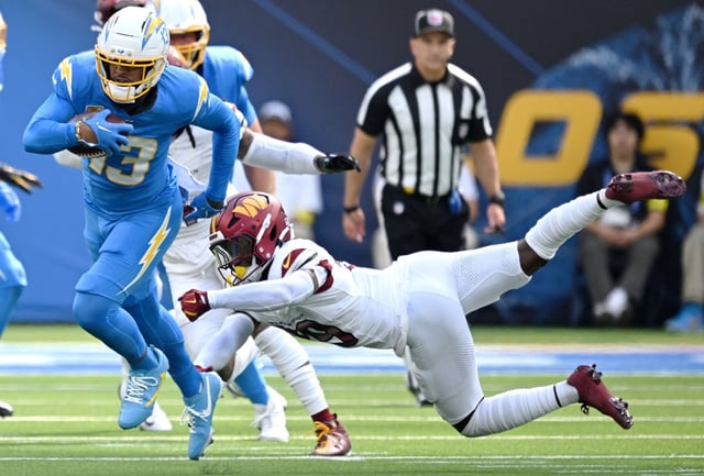 Chargers wide receiver Keenan Allen (13) breaks free from, Washington Commanders safety Jeremy Reaves (39) after the catch in the first half of the game at SoFi Stadium in Inglewood on Sunday, Oct. 5, 2025. (Photo by Terry Pierson, The Press-Enterprise/SCNG)