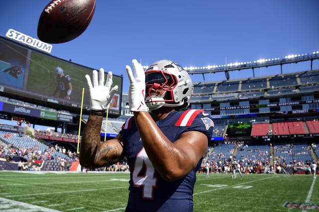Sep 28, 2025; Foxborough, Massachusetts, USA; New England Patriots running back Antonio Gibson (4) plays catch with fans prior to a game against the Carolina Panthers at Gillette Stadium. Mandatory Credit: Bob DeChiara-Imagn Images