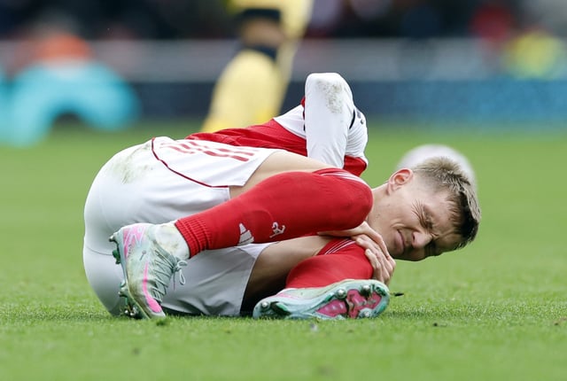 Soccer Football - Premier League - Arsenal v West Ham United - Emirates Stadium, London, Britain - October 4, 2025 Arsenal's Martin Odegaard reacts after sustaining an injury Action Images via Reuters/Peter Cziborra