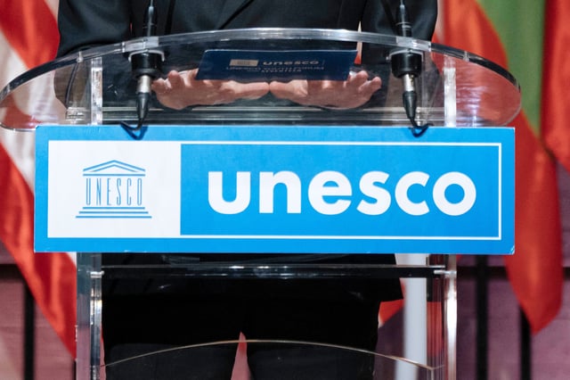 FILE - The UNESCO logo hangs from a podium in Paris, Nov. 14, 2023. (AP Photo/Lewis Joly, File)