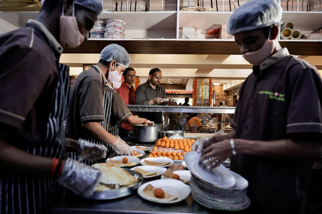 Staff serve food at a restaurant, which is serving dosas free of cost to people who cast their votes, during the second phase of the general elections, in Bengaluru, in Karnataka, India April 26, 2024. REUTERS/Navesh Chitrakar