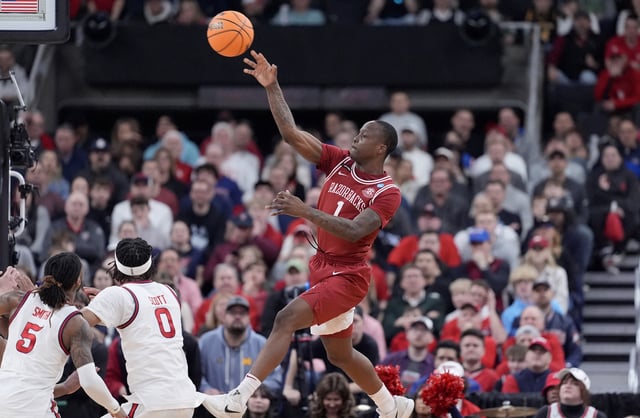 Mar 22, 2025; Providence, RI, USA; Arkansas Razorbacks guard Johnell Davis (1) passes against St. John's Red Storm guard Aaron Scott (0) during the first half of a second round men’s NCAA Tournament game at Amica Mutual Pavilion. Mandatory Credit: Gregory Fisher-Imagn Images