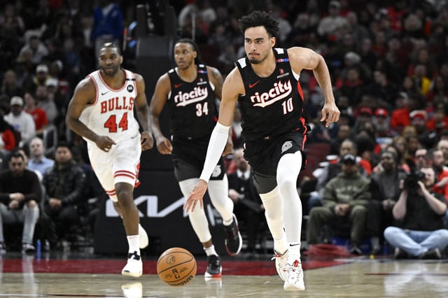 Apr 4, 2025; Chicago, Illinois, USA;  Portland Trail Blazers forward Justin Minaya (10) moves the ball against the Chicago Bulls during the first half at United Center. Mandatory Credit: Matt Marton-Imagn Images