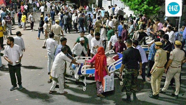 Patients, hospital staff and others gather after a fire broke out at the trauma centre of the state-run Sawai Man Singh (SMS) Hospital, late Sunday night, in Jaipur, 